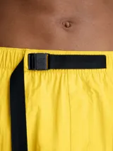 Short de baño amarillo de largo medio, con cintura elástica, cordón ajustable y hebilla con logo. Incluye bolsillos laterales y bolsillo trasero con cremallera.