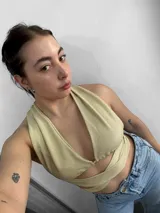 Top negro con escote halter y tiras cruzadas en el abdomen.