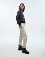 Pantalón tipo babucha sastrero negro, de tiro medio y corte pitillo hasta el tobillo. Presenta cintura elastizada, cartera falsa, bolsillos laterales y raya de aplomo en las piernas.