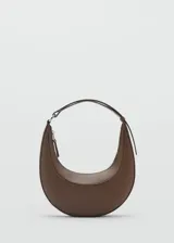 Bolso de hombro con diseño de media luna en color marrón. Presenta una estructura rígida, cierre superior con cremallera y asa corta integrada.