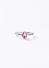 Anillo de plata 925 con una piedra central en forma de gota de color rosado y un pequeño detalle de zirconia redonda a su lado.