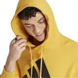 Canguro Adidas Essentials color mostaza con capucha, cordones ajustables, bolsillo tipo canguro y logo de Adidas estampado en el pecho.