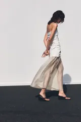 Vestido midi de escote palabra de honor con cuerpo drapeado y falda de tejido combinado con caída fluida. Presenta cierre con cremallera oculta.