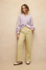 Pantalón negro de vestir, de corte recto y tiro alto, con pinzas y bolsillos laterales.