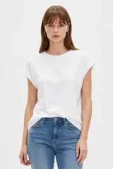 Remera blanca de algodón con cuello redondo, diseño holgado y mangas cortas con vuelta.