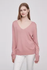 Sweater de punto color rosado, con cuello en V, manga larga y diseño holgado.