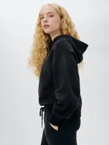 Buzo con capucha de corte holgado, confeccionado en algodón, con puños y ruedo acanalados.