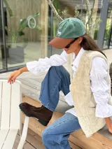 Botas cortas de cuero gamuzado color marrón oscuro, con suela track de goma negra y cierre frontal. Presentan un detalle de dos cruces bordadas a mano en tonos naranja y rojo en el lateral exterior.