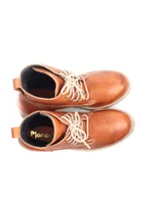 Borcego de cuero color marrón con cordones, caña media y taco cuadrado de goma con suela dentada.