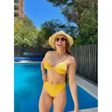Bikini de dos piezas color amarillo, compuesto por un corpiño triangular con copas desmontables y una bombacha de tiro alto con diseño de corte clásico.
