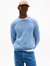 Sweater celeste de punto texturizado con cuello redondo y logo de Tommy Hilfiger bordado en el pecho.