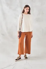 Pantalón color ladrillo de corte ancho, con cintura elastizada y bolsillos laterales.