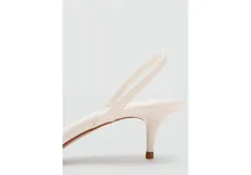 Sandalia de tacón bajo tipo kitten heel, color blanco, con diseño de tiras finas y cierre de pulsera en el talón.