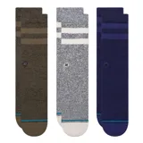 Pack de tres pares de medias Stance modelo The Joven, de caña alta, confeccionadas en algodón con amortiguación estratégica. Incluye un par verde militar con rayas oscuras, un par gris melange con rayas blancas y un par azul marino con rayas azules.