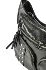 Cartera tipo hobo de poliuretano símil cuero color negro, con diseño slouchy y múltiples bolsillos frontales con cierre y tachas metálicas decorativas. Cuenta con correa ajustable para el hombro y detalles de tiras colgantes en los cierres.