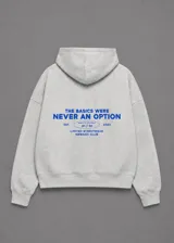Hoodie gris melange con capucha, de corte boxy fit amplio, con estampado azul en la espalda con la inscripción "The basics were never an option".
