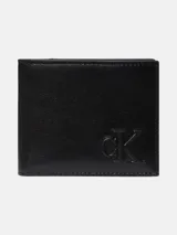 Billetera bifold de cuero negro con diseño compacto y monograma de Calvin Klein grabado en relieve en la parte frontal. Cuenta con múltiples ranuras para tarjetas y compartimento para billetes.