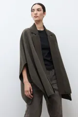Capa de tejido de punto en color verde oliva, con diseño abierto, solapas tipo blazer y cuello clásico. Presenta una caída fluida y corte holgado.