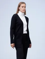 Cardigan abierto de tejido acanalado, con mangas largas y diseño de corte recto. Confeccionado por la marca Rio & Rian.