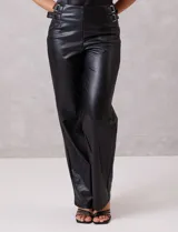 Pantalón de cuero sintético marca Dictionary, de corte recto y tiro alto. Presenta detalles de doble hebilla metálica en ambos laterales de la cintura.