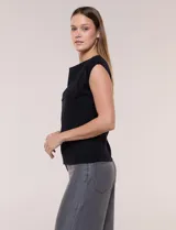 Buzo sin mangas de punto fino color beige, con calce al cuerpo y escote volcado estructurado con solapa superpuesta en el pecho.