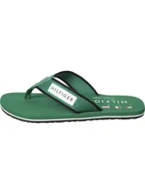 Ojotas Tommy Hilfiger verdes con suela blanca y tira de poliéster trenzado con logo de la marca.