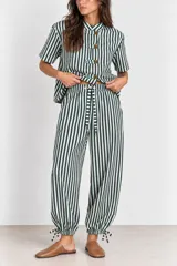 Pantalón de algodón a rayas verde oscuro y blanco, de corte holgado estilo globo con cintura elástica, bolsillos laterales y bajos ajustables con cordón.
