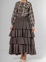 Falda larga de micro corderoy color marrón oscuro, con diseño de volados en capas y elástico en toda la cintura.