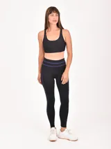 Calza deportiva negra con detalles de líneas finas en color fucsia en la cintura y los laterales.