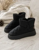 Botas tipo pantubota de caña baja, color negro, con diseño acolchado en forma de rombos y suela de plataforma plana. Presentan interior forrado en piel sintética y detalle de etiqueta en el lateral.
