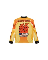 Remera de motocross manga larga marca Deus Ex Machina, en tonos azules con gráficos estampados en color rosa y negro. Presenta cuello redondo, puños elásticos y diseño deportivo con logotipos de la marca.