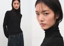 Jersey Luccac negro de cuello alto y manga larga, de corte recto y diseño clásico.