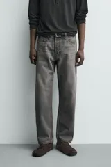 Jeans regular fit de denim de algodón en color gris con efecto lavado, tiro medio, diseño de cinco bolsillos y cierre frontal con botones.