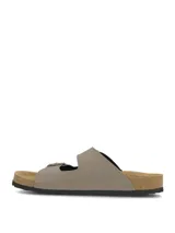 Sandalias estilo Birkenstock de color marrón claro, con dos tiras ajustables con hebillas metálicas, plantilla anatómica con efecto corcho y suela negra.