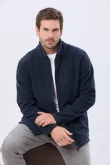 Campera polar de abrigo azul marino, con cuello alto, cierre frontal y bolsillos laterales y en el pecho con cierre.
