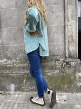 Polerón celeste de peluche con cuello alto y puños blancos.