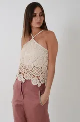 Top de crochet color crudo con motivo de medallones, escote halter y diseño evasé.