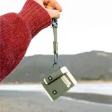 Billetera elástica de tejido resistente color gris con estampado de líneas topográficas en azul, diseñada para tarjetas y efectivo, con anillo metálico lateral.