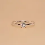 Anillo de plata 925 con diseño minimalista, presenta una circonia central engastada en bisel.