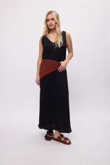 Vestido blanco sin mangas, confeccionado en algodón con textura, presenta un escote en V con detalle de trenzado en el borde y una placa metálica pequeña con logo en la espalda.