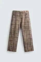 Jeans de corte holgado y amplio en toda la pierna, tiro medio. Tejido rígido con estampado a cuadros con efecto lavado. Cuenta con cinco bolsillos y cierre frontal con cremallera y botón.