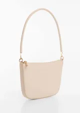 Bolso mini color beige con efecto piel, asa de hombro y cierre de cremallera.