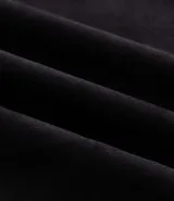 Remera oversize de tejido tipo gamuza sintética negra, con cuello redondo, manga corta y bordado de cruz gótica en el pecho.
