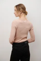 Buzo de morley color crema, con cuello bote y manga larga. Presenta un diseño de punto acanalado y un detalle de franja horizontal en el pecho.