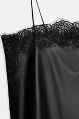 Top de escote recto con tirantes finos ajustables, confeccionado en tejido con acabado efecto piel y detalle de aplicación de encaje a tono en los bordes.