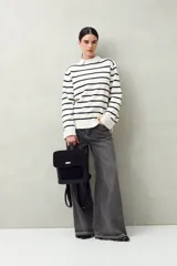 Mochila estructurada color marrón oscuro, con frente en acabado gamuzado y cuerpo en símil cuero texturizado. Tiene asa superior y correas regulables.