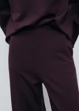 Pantalón de corte recto y pernera ancha, color bordó, con cintura elástica y bolsillos laterales.