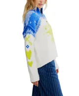 Sweater blanco con cuello alto y media cremallera, diseño holgado y extragrande. Presenta un patrón de punto jacquard en azul y amarillo neón, con motivos florales y geométricos. Los puños y el dobladillo son acanalados.