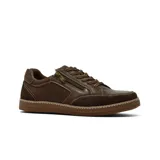 Zapato casual de cuero color marrón, con diseño de paneles combinados en cuero liso y gamuza. Presenta cierre lateral decorativo, cordones al tono y suela de goma con costuras visibles.