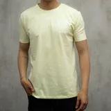 Remera color amarillo claro de algodón con estampa frontal en blanco con el texto "American Native Goods. Proudly made by Dixon Co.".